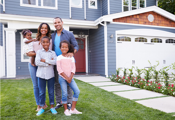 Happy family in front of new house