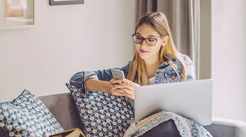 Woman sitting on couch with phone